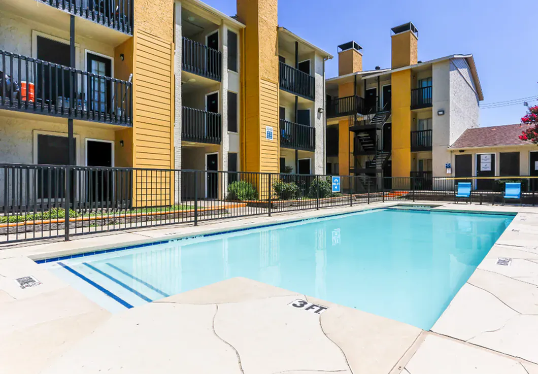 The Dahlia, a 206-unit AXXIS Capital apartment community in Dallas, Texas, seen across its pool